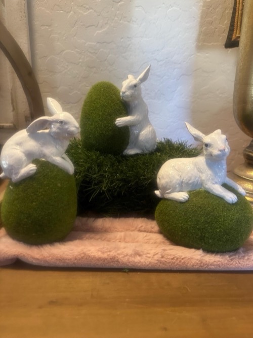 Delicate bunnies with grass eggs
